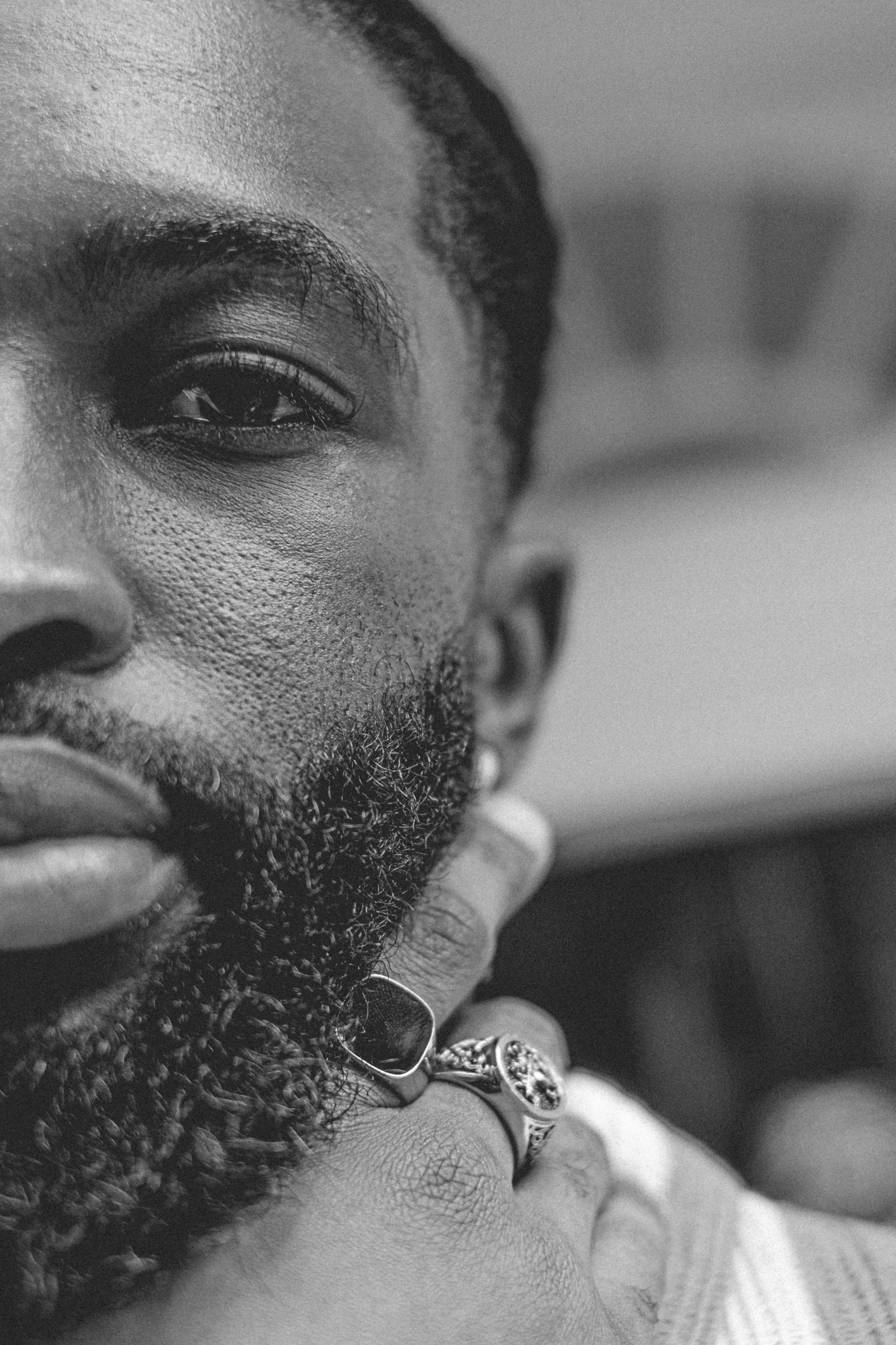 Black and white close-up portrait with ringed hand